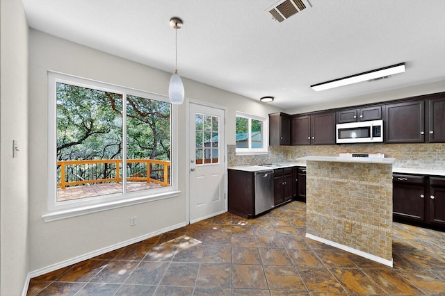 1115 Byers Ln, Austin, TX 78753 - kitchen featuring stainless steel appliances, light countertops, and dark brown cabinetry