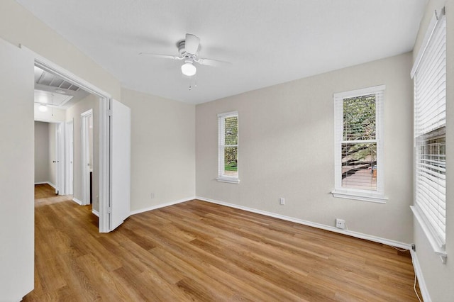 1115 Byers Ln, Austin, TX 78753 - spare room with light wood-style floors, a ceiling fan, and baseboards