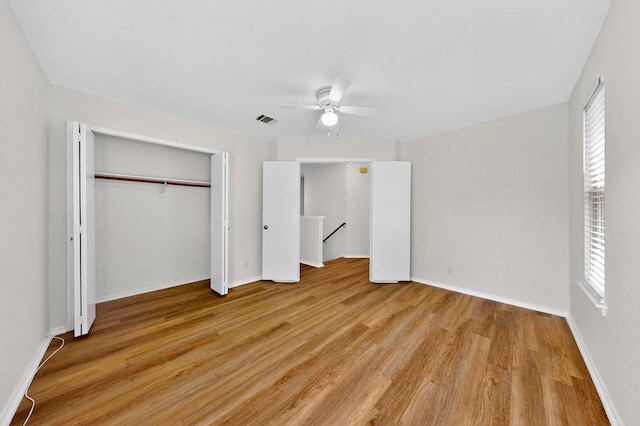 1115 Byers Ln, Austin, TX 78753 - unfurnished bedroom with light wood-style floors, multiple windows, a closet, and baseboards