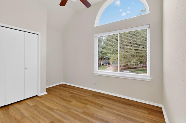 1115 Byers Ln, Austin, TX 78753 - unfurnished bedroom featuring multiple windows, wood finished floors, baseboards, and vaulted ceiling