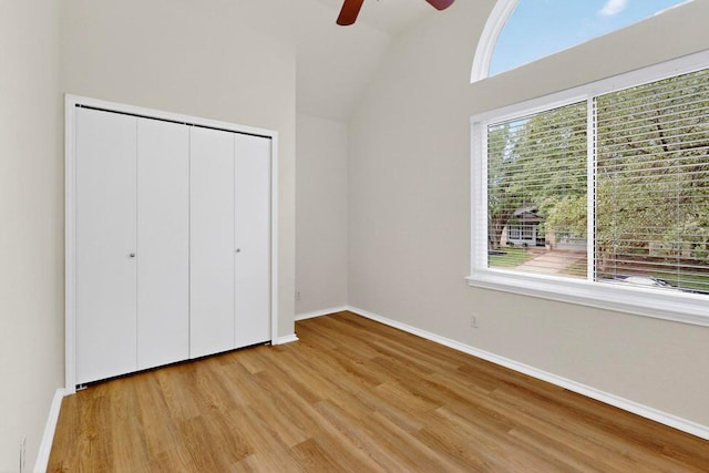 1115 Byers Ln, Austin, TX 78753 - unfurnished bedroom featuring light wood-style floors, baseboards, vaulted ceiling, a closet, and a ceiling fan