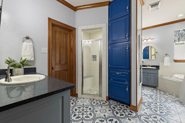 3 Hillview Dr, Round Rock, TX 78664 - full bath with ornamental molding, a shower stall, two vanities, a garden tub, and tile patterned floors