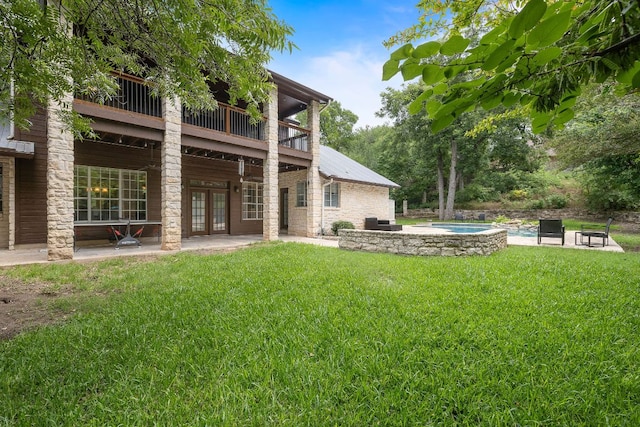 3 Hillview Dr, Round Rock, TX 78664 - rear view of house with french doors, a patio area, a lawn, an outdoor pool, and a jacuzzi