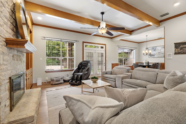 3 Hillview Dr, Round Rock, TX 78664 - living area featuring wood finished floors, a chandelier, a fireplace, a ceiling fan, and crown molding