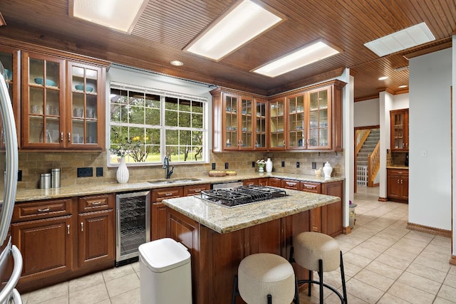 3 Hillview Dr, Round Rock, TX 78664 - kitchen with wine cooler, a sink, light tile patterned flooring, gas stovetop, and wood ceiling