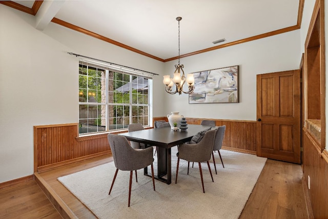 3 Hillview Dr, Round Rock, TX 78664 - dining space featuring light wood-style floors, wainscoting, a chandelier, ornamental molding, and wooden walls
