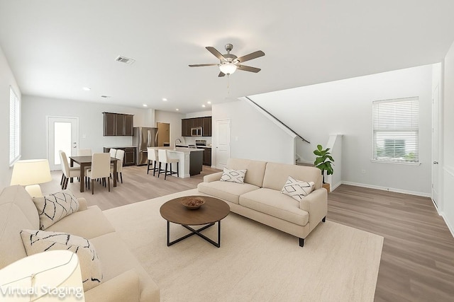 202 Delaware Mountains Ter, Dripping Springs, TX 78620 - living room with light wood finished floors, ceiling fan, baseboards, recessed lighting, and stairway