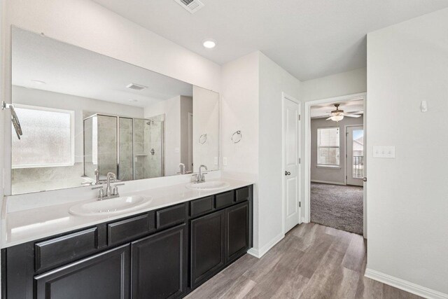 202 Delaware Mountains Ter, Dripping Springs, TX 78620 - full bathroom with a shower stall, double vanity, wood finished floors, and baseboards