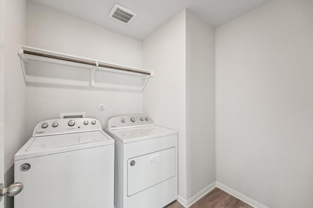 202 Delaware Mountains Ter, Dripping Springs, TX 78620 - washroom with washer and clothes dryer, baseboards, and wood finished floors
