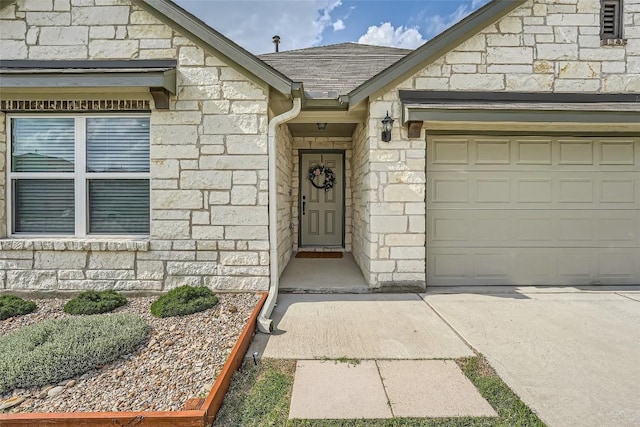 12904 Cerro Castellan Trce, Manor, TX 78653 - doorway to property featuring stone siding, a garage, and concrete driveway