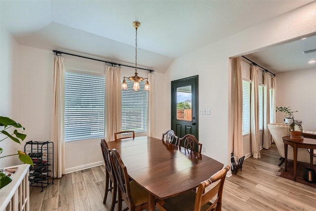 12904 Cerro Castellan Trce, Manor, TX 78653 - dining space with light wood-style flooring, a chandelier, lofted ceiling, and baseboards