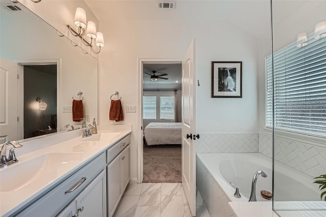 12904 Cerro Castellan Trce, Manor, TX 78653 - full bathroom with double vanity, connected bathroom, a garden tub, ceiling fan, and marble finish flooring