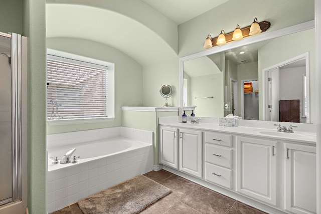123 Justin Leonard Dr, Round Rock, TX 78664 - bathroom featuring a garden tub, double vanity, tile patterned flooring, and a shower with shower door