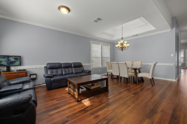 123 Justin Leonard Dr, Round Rock, TX 78664 - living room featuring a chandelier, a tray ceiling, healthy amount of natural light, wood finished floors, and crown molding