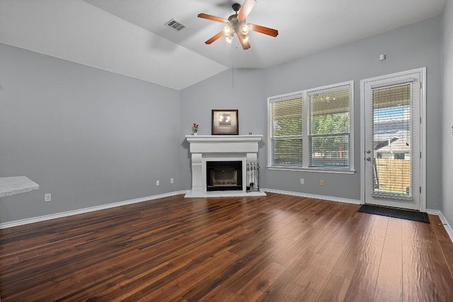 123 Justin Leonard Dr, Round Rock, TX 78664 - unfurnished living room with ceiling fan, a glass covered fireplace, dark wood finished floors, lofted ceiling, and baseboards