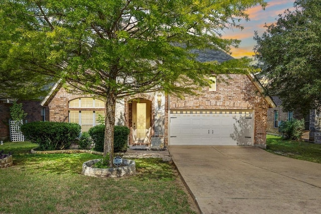 123 Justin Leonard Dr, Round Rock, TX 78664 - view of front of home featuring brick siding, driveway, and a front lawn