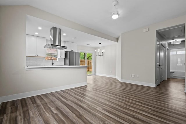 4913 Single Shot Cir, Austin, TX 78723 - unfurnished living room featuring attic access, dark wood-style floors, recessed lighting, and a chandelier