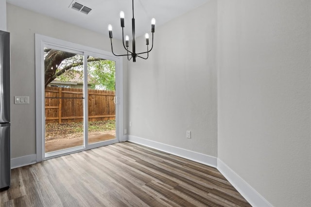 4913 Single Shot Cir, Austin, TX 78723 - unfurnished dining area with a chandelier and wood finished floors