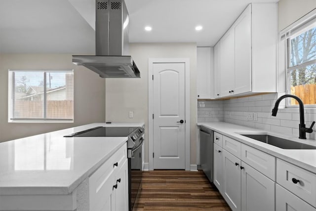 4913 Single Shot Cir, Austin, TX 78723 - kitchen featuring island exhaust hood, appliances with stainless steel finishes, dark wood-type flooring, white cabinetry, and recessed lighting