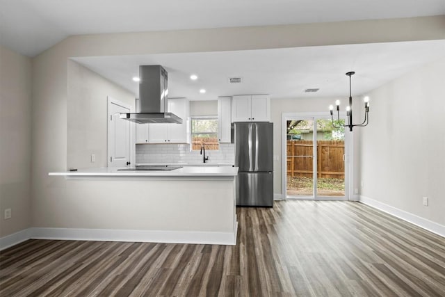 4913 Single Shot Cir, Austin, TX 78723 - kitchen featuring freestanding refrigerator, extractor fan, dark wood-style flooring, light countertops, and backsplash