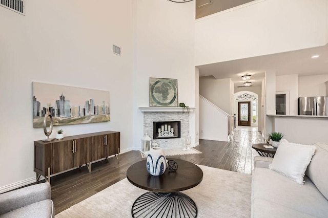 4508 Three Arrows Ct, Cedar Park, TX 78613 - living room featuring wood-type flooring, a high ceiling, baseboards, and a fireplace