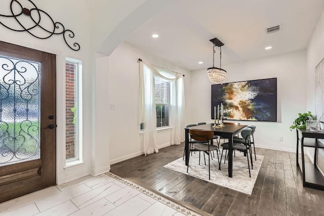 4508 Three Arrows Ct, Cedar Park, TX 78613 - dining room featuring arched walkways, baseboards, recessed lighting, and wood finished floors
