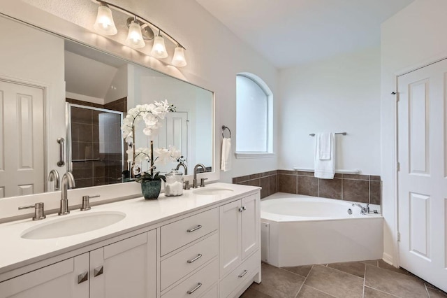 4508 Three Arrows Ct, Cedar Park, TX 78613 - bathroom with double vanity, a shower stall, a garden tub, and tile patterned floors