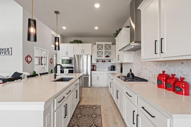 17804 Hattie Trce, Austin, TX 78738 - kitchen featuring stainless steel appliances, a sink, wall chimney range hood, decorative backsplash, and a kitchen island with sink