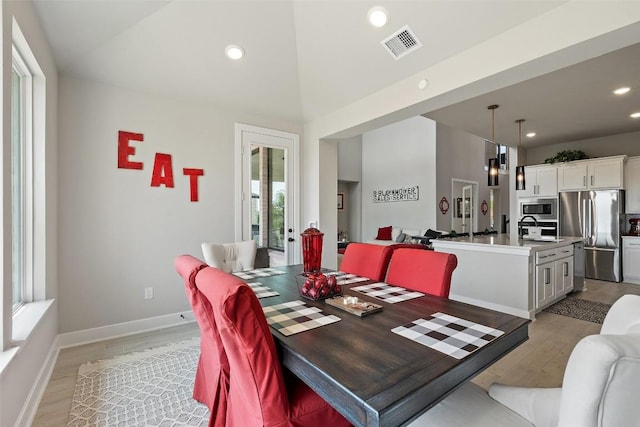 17804 Hattie Trce, Austin, TX 78738 - dining space with light wood-style flooring, recessed lighting, baseboards, and high vaulted ceiling