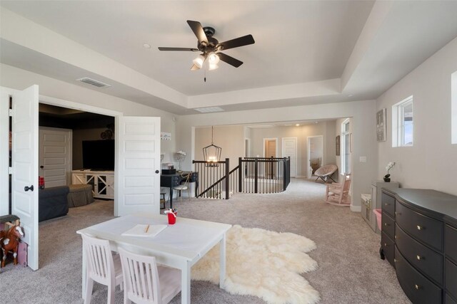 17804 Hattie Trce, Austin, TX 78738 - living room with light carpet, ceiling fan, a tray ceiling, and a chandelier