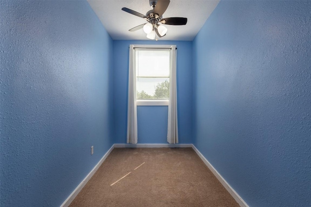 15055 Fm 32, Blanco, TX 78606 - spare room featuring a textured wall, a ceiling fan, carpet flooring, and baseboards