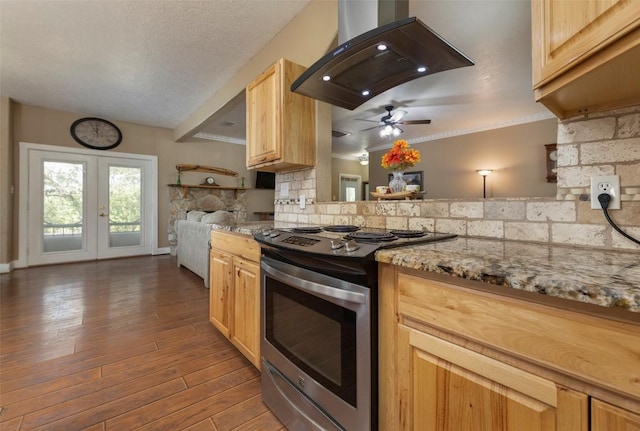 15055 Fm 32, Blanco, TX 78606 - kitchen with stainless steel electric range, island range hood, tasteful backsplash, a ceiling fan, and light brown cabinetry