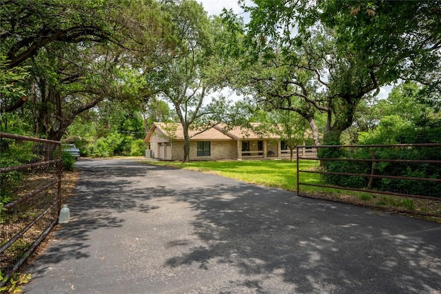 42 Laurel Hill St, Austin, TX 78737 - view of front of home featuring asphalt driveway and a garage