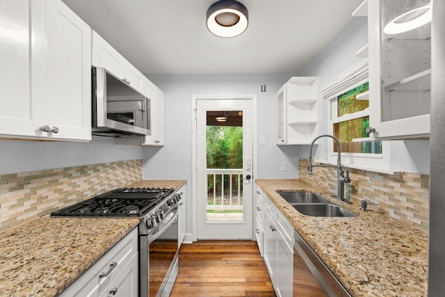 1904 S 6th St, Austin, TX 78704 - kitchen featuring stainless steel appliances, open shelves, healthy amount of natural light, and white cabinetry
