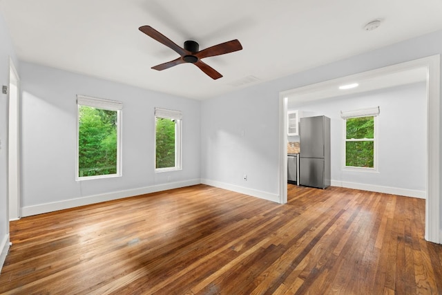 1904 S 6th St, Austin, TX 78704 - empty room featuring healthy amount of natural light, hardwood / wood-style floors, a ceiling fan, and a smoke detector