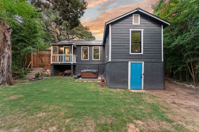1904 S 6th St, Austin, TX 78704 - rear view of property with a jacuzzi, a lawn, a metal roof, and a deck