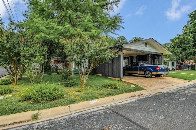 1601 E 19th St, Georgetown, TX 78626 - view of front of property with concrete driveway, a carport, and a front lawn