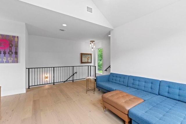 1708 Morrow St, Austin, TX 78757 - living area with wood finished floors, vaulted ceiling, and an upstairs landing