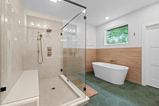 1708 Morrow St, Austin, TX 78757 - full bath featuring a stall shower, a freestanding bath, tile patterned flooring, a wainscoted wall, and tile walls