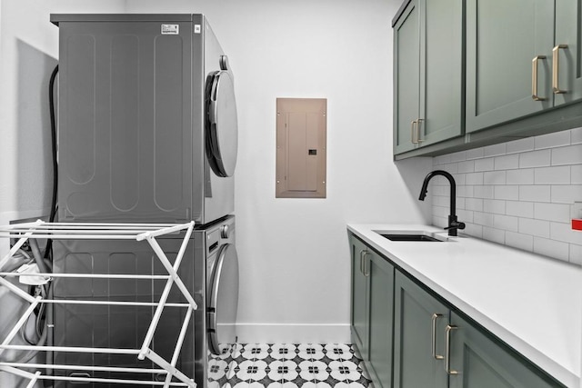 1708 Morrow St, Austin, TX 78757 - laundry area featuring stacked washing machine and dryer, electric panel, cabinet space, baseboards, and light tile patterned floors