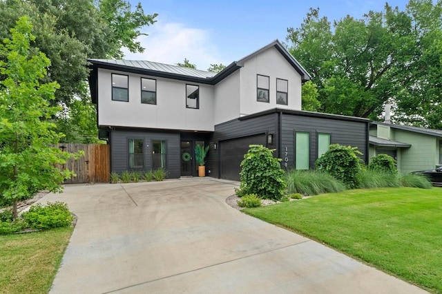 1708 Morrow St, Austin, TX 78757 - contemporary house with a garage, concrete driveway, a standing seam roof, stucco siding, and metal roof