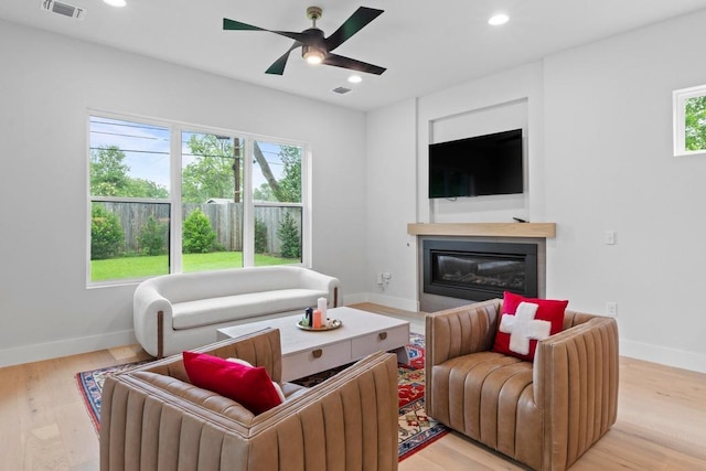 1708 Morrow St, Austin, TX 78757 - living room with healthy amount of natural light, baseboards, a glass covered fireplace, recessed lighting, and a ceiling fan
