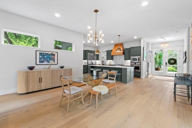 1708 Morrow St, Austin, TX 78757 - dining area with a chandelier, recessed lighting, light wood-style flooring, and baseboards