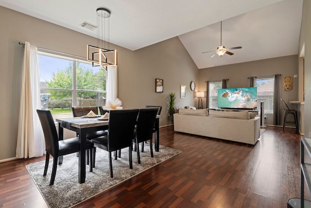 14034 Chelseahurst Ln, Houston, TX 77047 - dining area featuring a chandelier, a ceiling fan, dark wood-type flooring, high vaulted ceiling, and baseboards