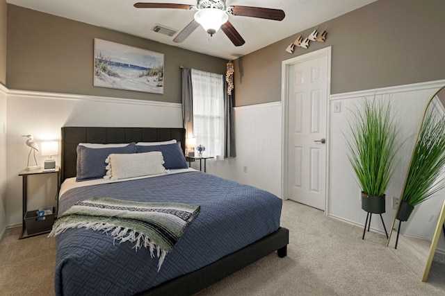 14034 Chelseahurst Ln, Houston, TX 77047 - carpeted bedroom featuring a wainscoted wall and ceiling fan