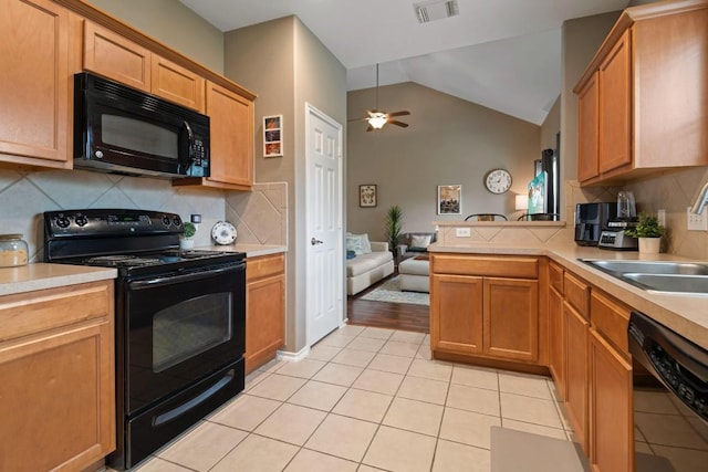 14034 Chelseahurst Ln, Houston, TX 77047 - kitchen with black appliances, ceiling fan, light countertops, a peninsula, and vaulted ceiling