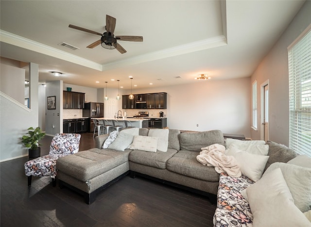 6900 Midlothian Dr, Austin, TX 78754 - living room featuring a tray ceiling, ornamental molding, ceiling fan, dark wood-style flooring, and recessed lighting