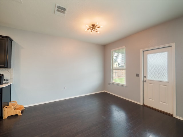 6900 Midlothian Dr, Austin, TX 78754 - unfurnished dining area with dark wood finished floors and baseboards