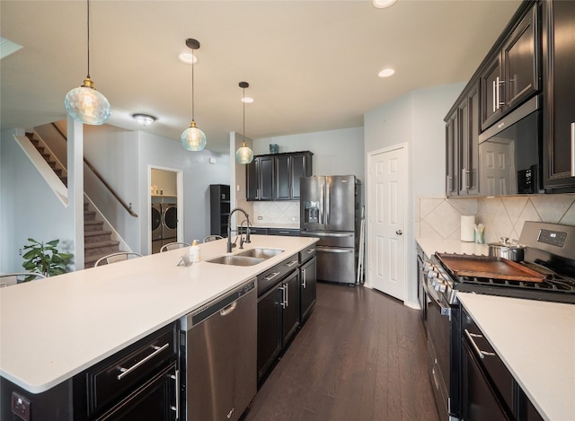 6900 Midlothian Dr, Austin, TX 78754 - kitchen featuring stainless steel appliances, independent washer and dryer, a sink, light countertops, and tasteful backsplash