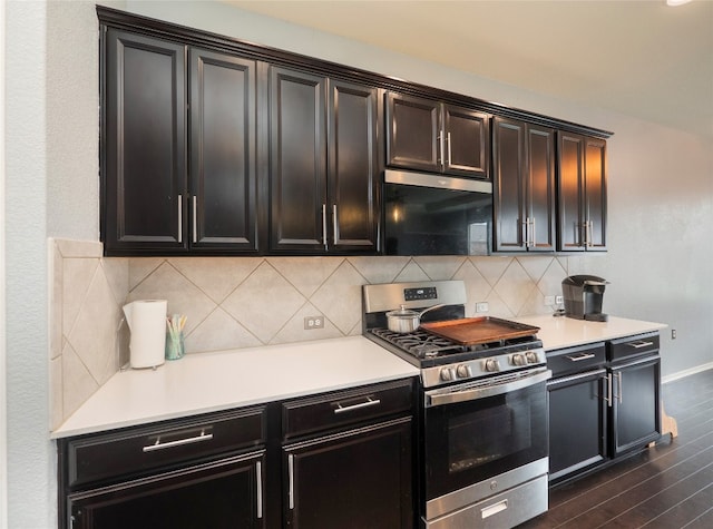 6900 Midlothian Dr, Austin, TX 78754 - kitchen with stainless steel range with gas cooktop, dark wood-type flooring, light countertops, and tasteful backsplash